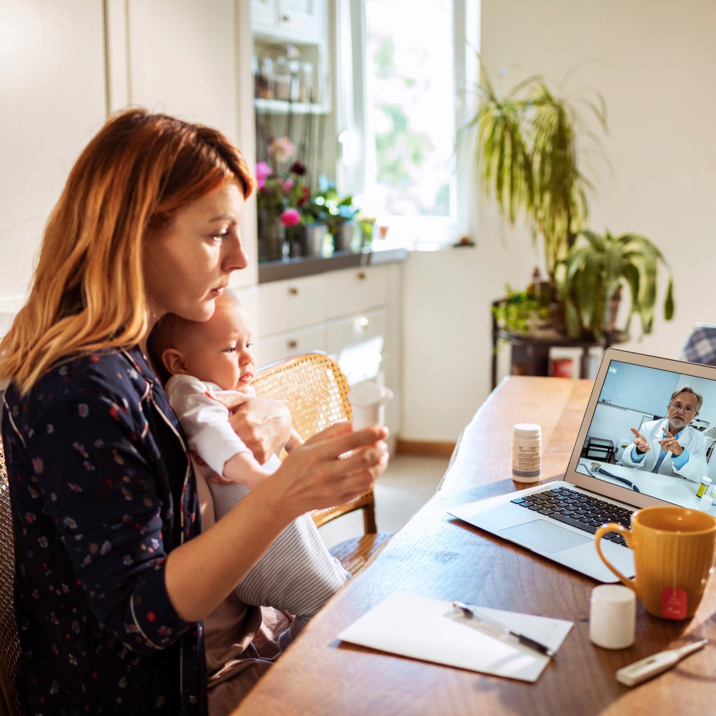 Data and privacy - mother on call with doctor at laptop