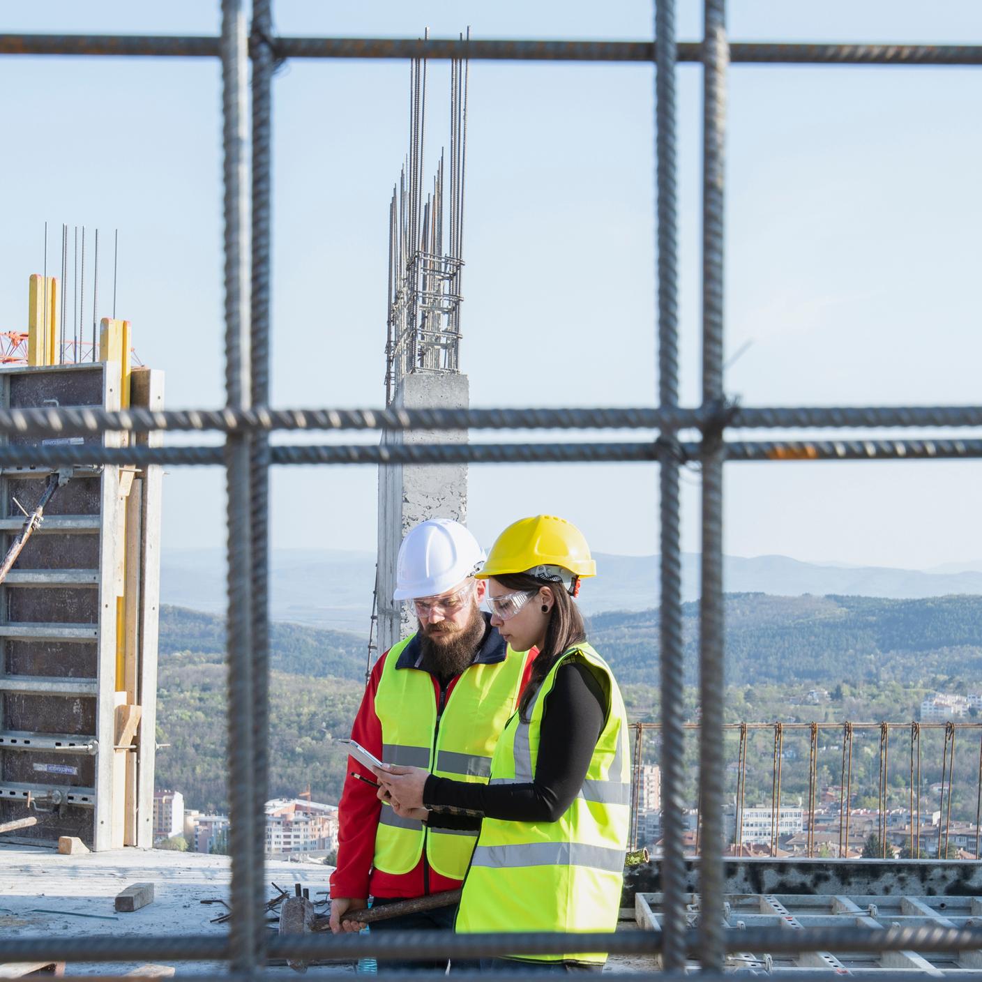 Construction workers standing on outdoor construction site a