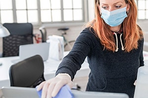 woman cleaning desk